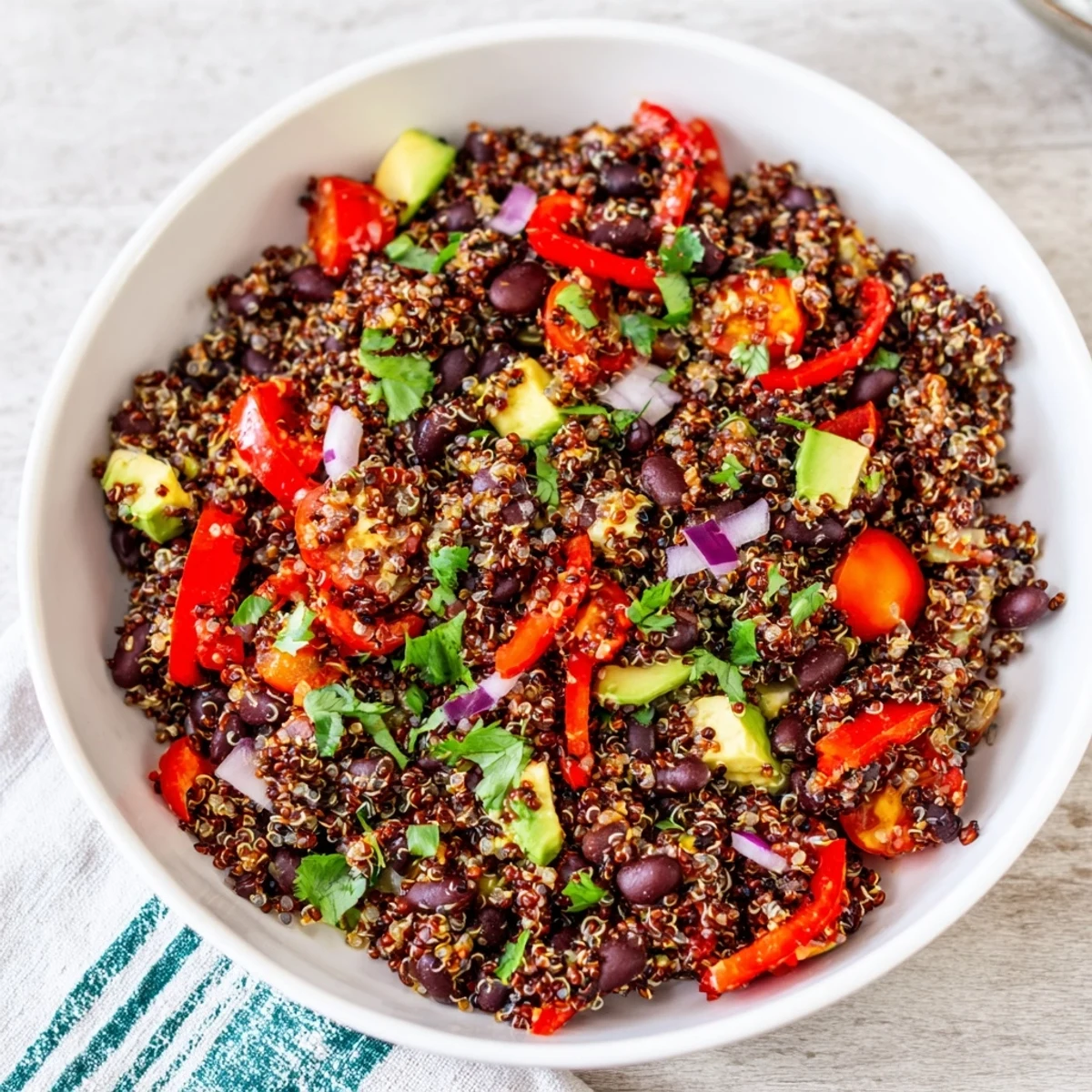 A colorful bowl of refreshing quinoa and black bean salad with vibrant lime dressing.