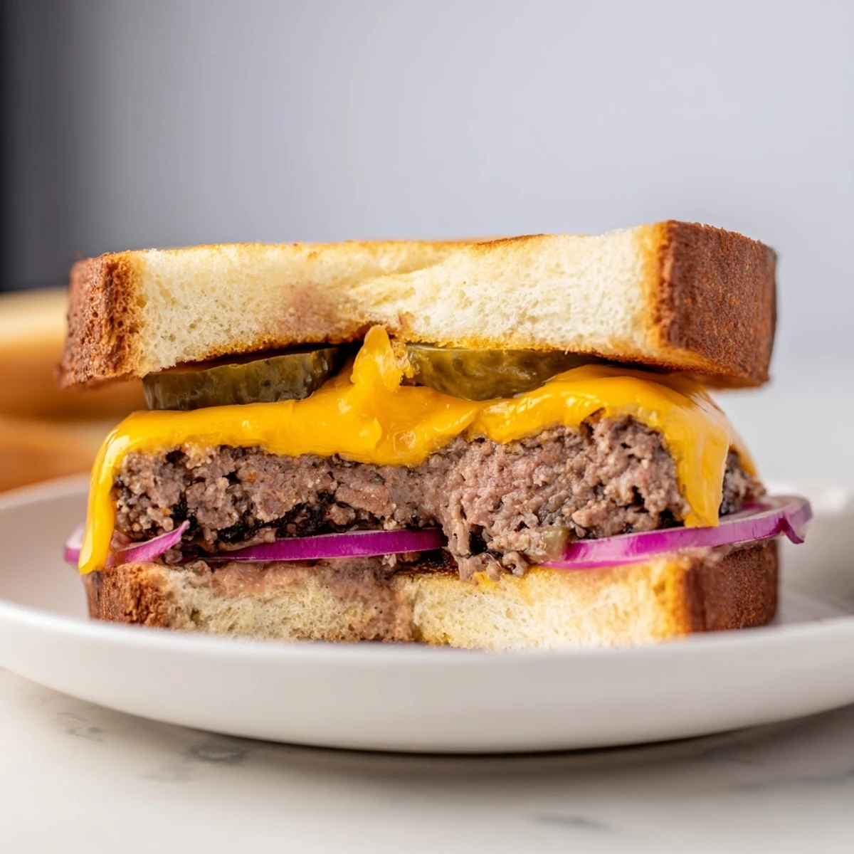 Golden, gooey Smashed Burger Grilled Cheese, a perfect comfort food with melty cheddar and a crispy crust.