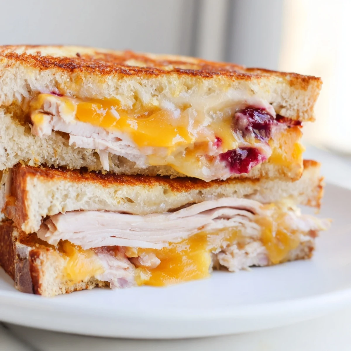 Golden toasted sourdough grilled cheese layered with smoky turkey, sharp cheddar, and a tangy cranberry spread.