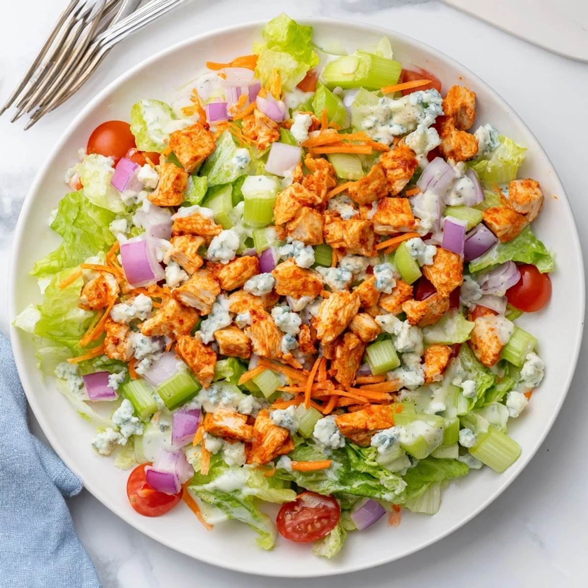 A vibrant Buffalo Chicken Chopped Salad with spicy buffalo chicken, crisp romaine lettuce, and creamy blue cheese crumbles.