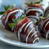Chocolate-Covered Strawberries with white chocolate drizzle, perfect for romantic date nights or parties.