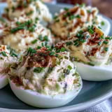 Million Dollar Deviled Eggs showcase creamy yolk filling piped into tender egg white halves on a platter.