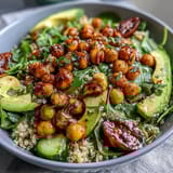 Vibrant lemon vinaigrette grain bowls with roasted chickpeas, fresh veggies, and creamy avocado for a healthy, plant-based meal.  