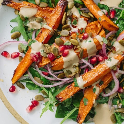 Vibrant photo of Roasted Carrot Salad, featuring tender carrots and creamy tahini-lemon drizzle.
