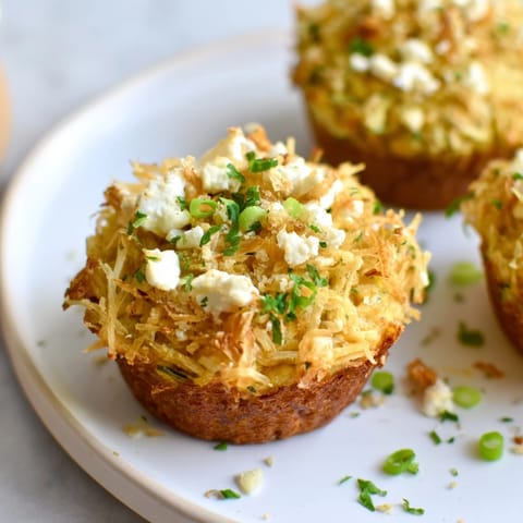 Golden-brown zucchini and feta muffins, a delicious Mediterranean-inspired snack, perfect for sharing.