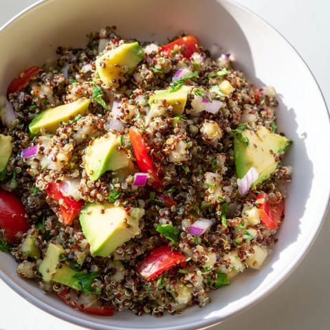 Chilled refreshing quinoa and black bean salad featuring avocado, ready to serve and enjoy.