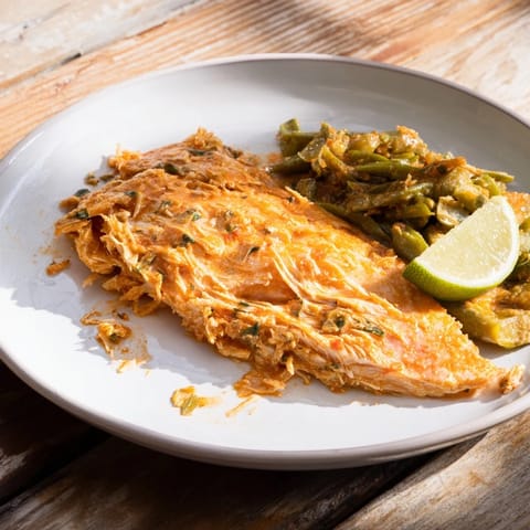 Tender, flaky Sheet Pan Lemon Herb Tilapia and Green Beans, with vibrant herbs, alongside crisp-tender green beans.