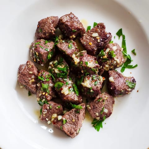 Golden-brown Garlic Butter Steak Bites, aromatic with garlic, in a rich, buttery pan sauce.