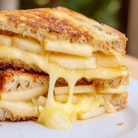 Freshly ground black pepper and optional Dijon mustard add savory depth to the warm sandwich.